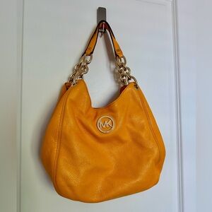 Michael Kors Handbag - yellow/orange color with gold accents